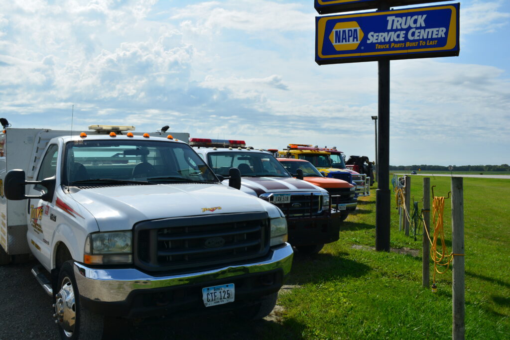 A lineup of Tony's medium-duty tow trucks ready to handle a variety of towing needs in Northern Iowa.