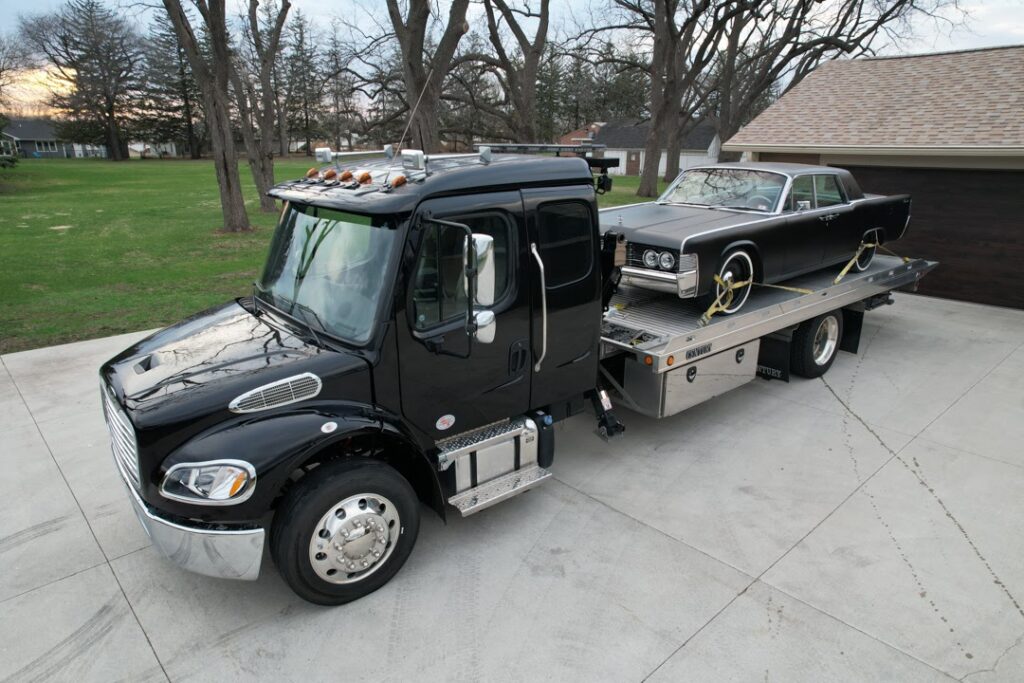 A Tony's flatbed tow truck, ensuring secure and reliable transport for vehicles in Northern Iowa.